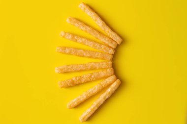 flat lay of delicious and crispy french fries on yellow clipart