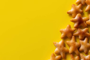 top view of delicious cookies in shape of stars on yellow