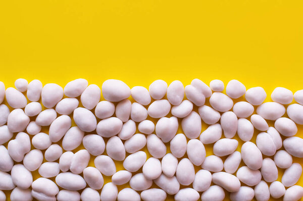 flay lay with tasty pine nuts on yellow background