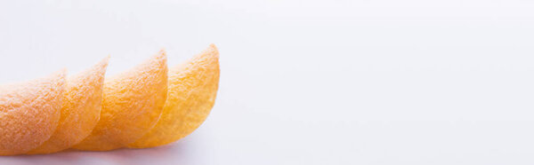 stacked and fried potato chips on white background, banner