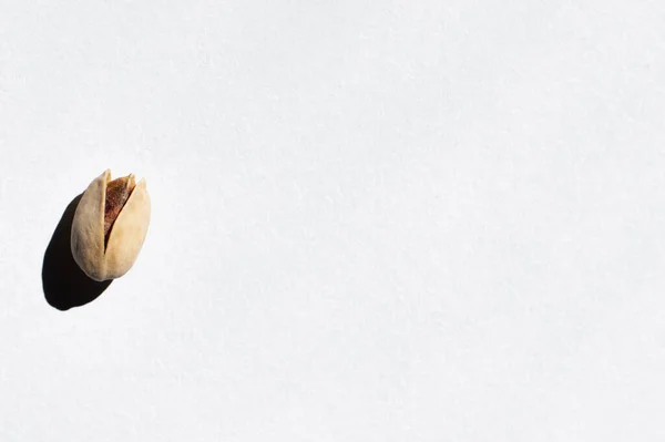Top View Single Cracked Pistachio Nut White Background — стоковое фото