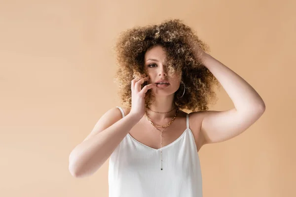 Jeune Femme Haut Blanc Touchant Cheveux Bouclés Isolés Sur Beige — Photo
