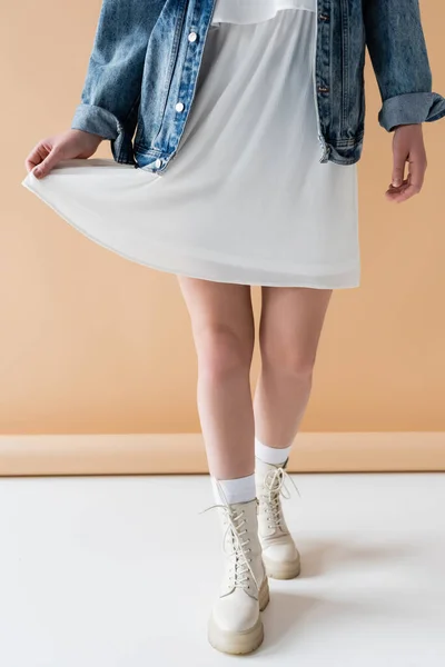 Cropped View Stylish Woman Touching Skirt While Walking Beige Background — Stock Photo, Image