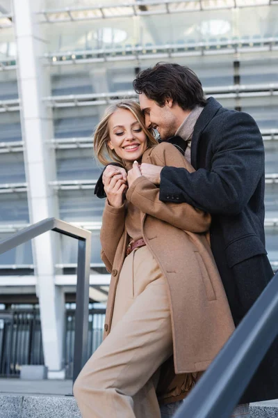 Cheerful Man Coat Embracing Young Stylish Girlfriend Urban Street — Stock Photo, Image