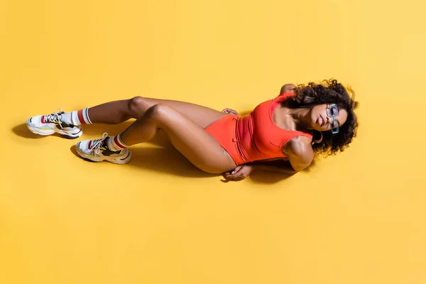 穿着红色泳衣 太阳镜和黄底运动鞋的性感非洲裔美国女人的头像 — 图库照片