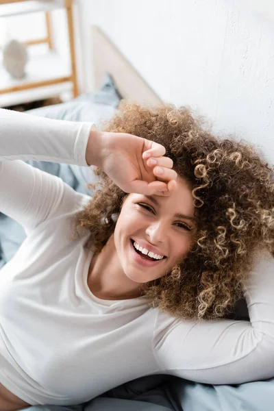 Curly Woman White Home Wear Laughing Camera Bedroom — Stock Photo, Image