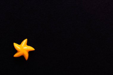 Siyah üzerine izole edilmiş deniz yıldızı şeklindeki parlak sarı küf manzarası