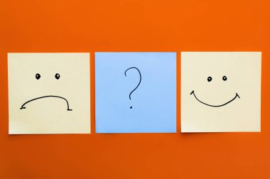 top view of cards with question mark near happy and upset emoticons on red background clipart
