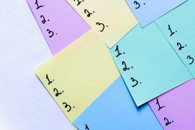 top view of multicolored sticky notes with numbers on white background clipart