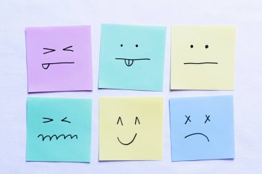 top view of paper cards with various emoticons on white background clipart