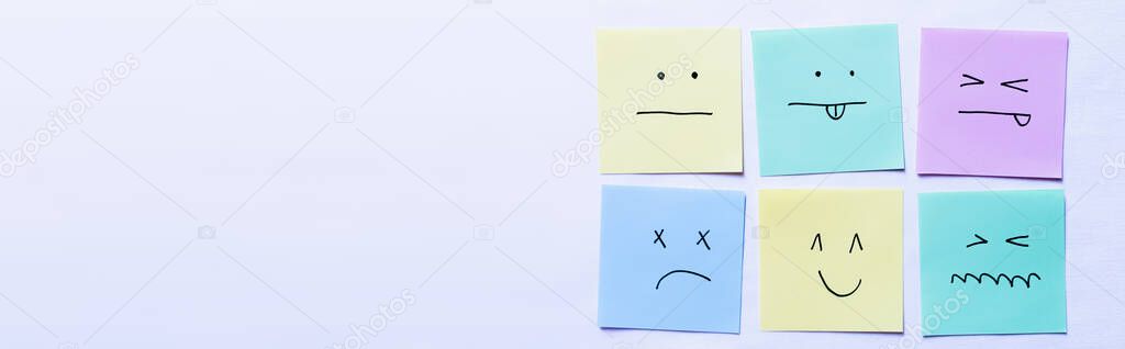 top view of paper cards with various smileys on white background, banner