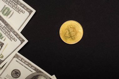 KYIV, UKRAINE - 26 Nisan 2022: Siyah üzerine izole edilmiş dolar ve kripto para üst görünümü 