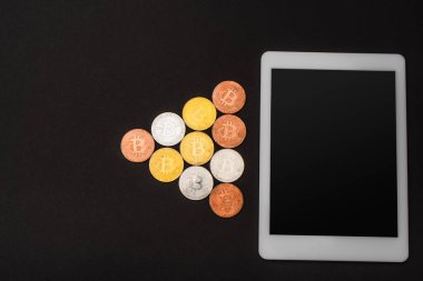 KYIV, UKRAINE - 26 Nisan 2022: Dijital tablet yakınlarında izole edilmiş kripto paraların üst görünümü 