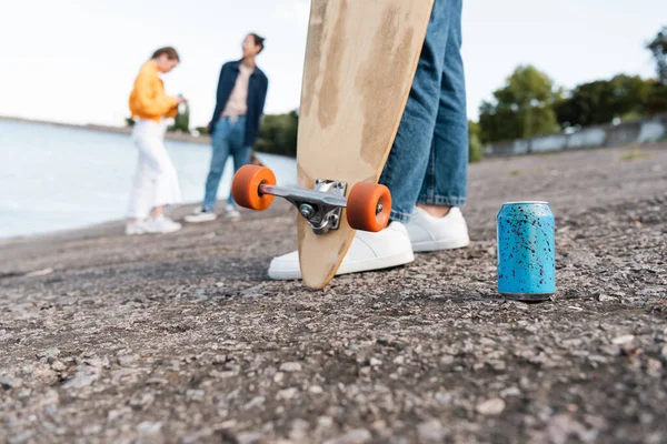 Partial View Skater Longboard Soda Can Blurred Friends River Bank — Stock Photo, Image