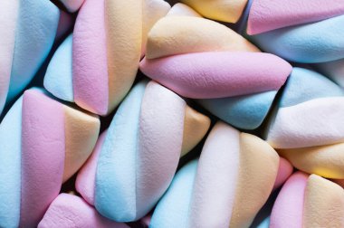 Close up view of colorful marshmallows isolated on black  clipart