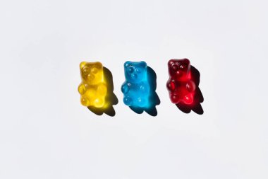 Top view of colorful gummy bears on white background  clipart