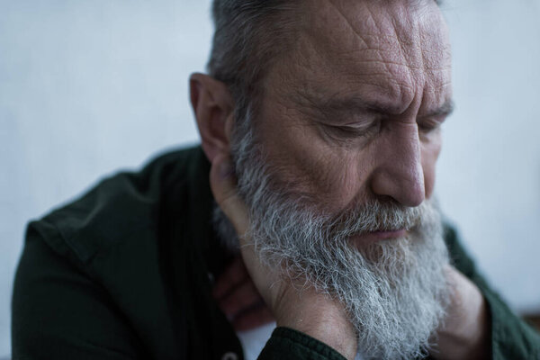 portrait of unhappy senior man with wrinkles suffering crisis 