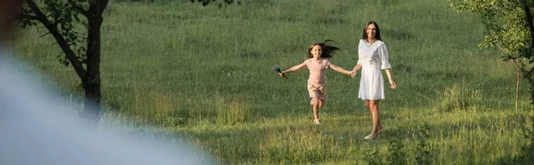 Excited Girl Holding Hands Mother While Walking Field Banner —  Fotos de Stock