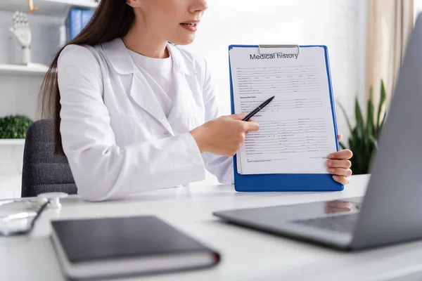 Cropped View Doctor Pointing Medical History Video Call Laptop Clinic — Photo