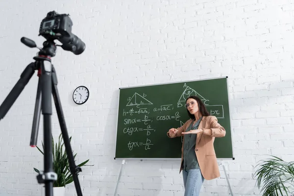 Teacher Gesturing Chalkboard Math Formulas Digital Camera Classroom — Stok fotoğraf