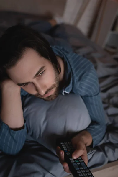 Bearded Man Clicking Channels While Lying Bed Night — Stok Foto