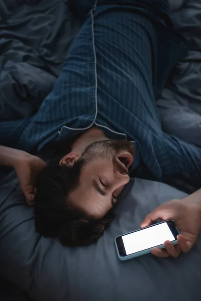Vista Superior Homem Exausto Bocejando Segurando Smartphone Cama Casa — Fotografia de Stock