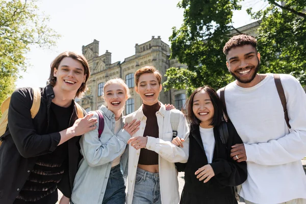 Positive Multiethnic Students Hugging Looking Camera Outdoors — Stock Photo, Image