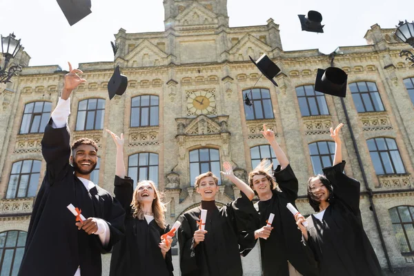 Low Angle View Interracial Bachelors Throwing Caps University Outdoors — Stock Photo, Image