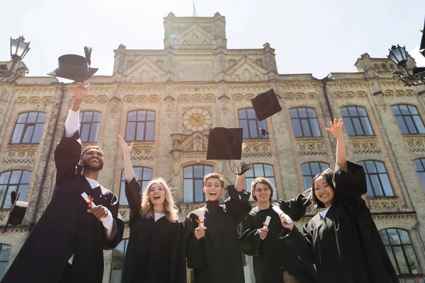 Low Angle View Happy Multiethnic Bachelors Throwing Caps University Outdoors — Stock Photo, Image