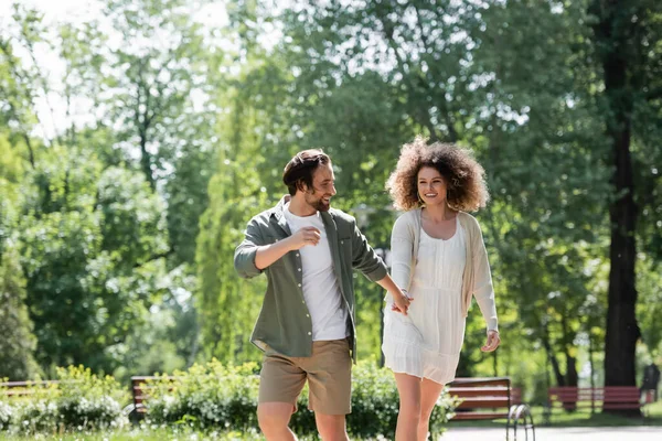 Joyful Young Couple Holding Hands While Walking Together Summer Park — Stockfoto