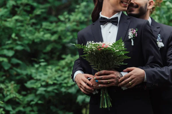 Cropped View Joyful Gay Couple Suits Holding Wedding Bouquet Green — ストック写真