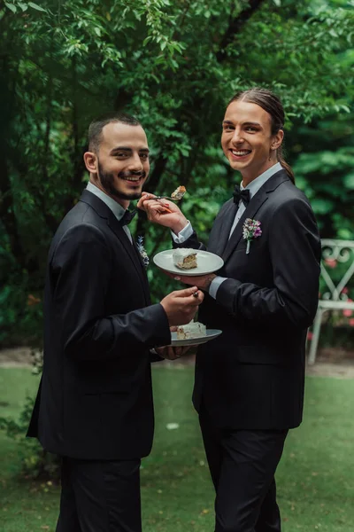 Pleased Gay Newlyweds Formal Wear Holding Wedding Cake — Stok fotoğraf
