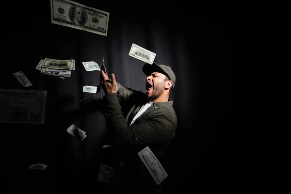 Excited Eastern Hip Hop Performer Cap Throwing Dollar Banknotes Black — Stock Photo, Image
