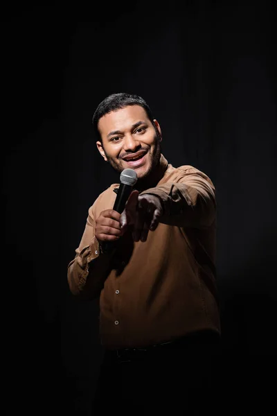 Happy Indian Comedian Shirt Bow Tie Holding Microphone Pointing Finger — Zdjęcie stockowe