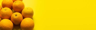 Top view of sweet oranges on yellow background with copy space, banner 