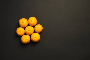 Siyah üzerine izole edilmiş yuvarlak şekilli mandalinalardan düz yatıyordu. 