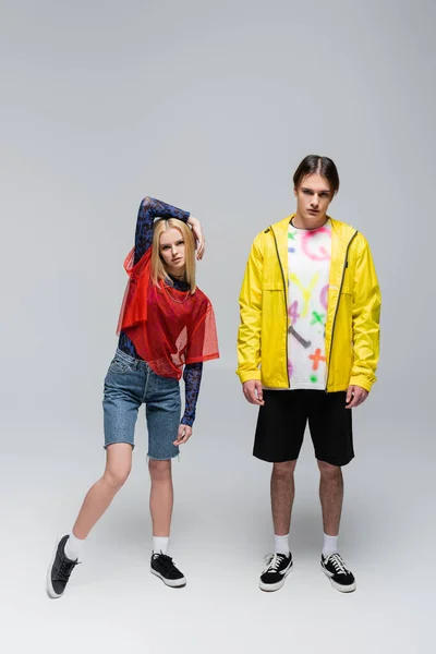 Full Length Trendy Couple Bright Clothes Posing Grey Background — Stock Fotó