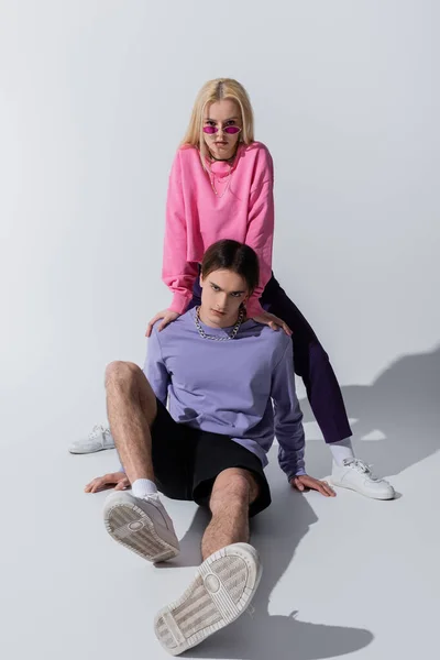 Young Couple Sweatshirts Sneakers Posing Grey Background — 스톡 사진