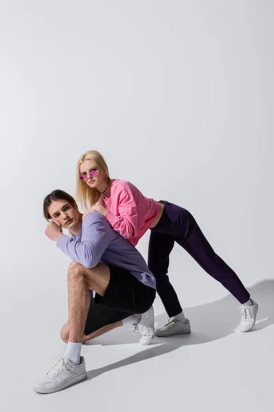 Stylish Young Couple Sneakers Sweatshirts Posing Grey Background — 图库照片