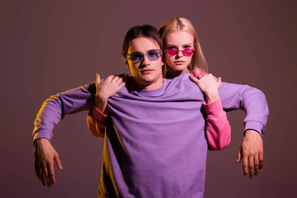 Blonde Woman Pink Sunglasses Hugging Boyfriend Isolated Purple Lighting —  Fotos de Stock
