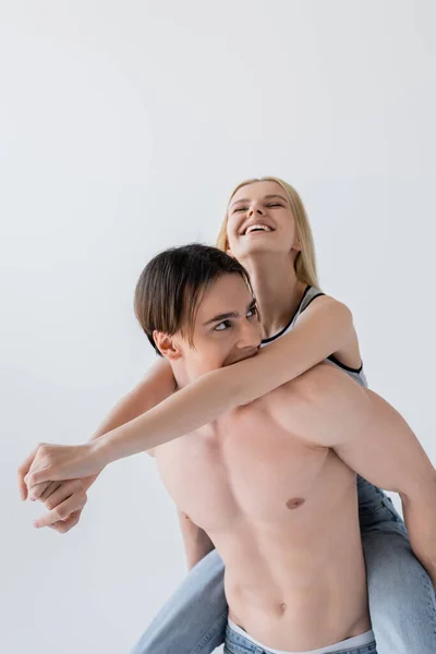 Shirtless Man Biting Cheerful Blonde Girlfriend Isolated Grey — 图库照片