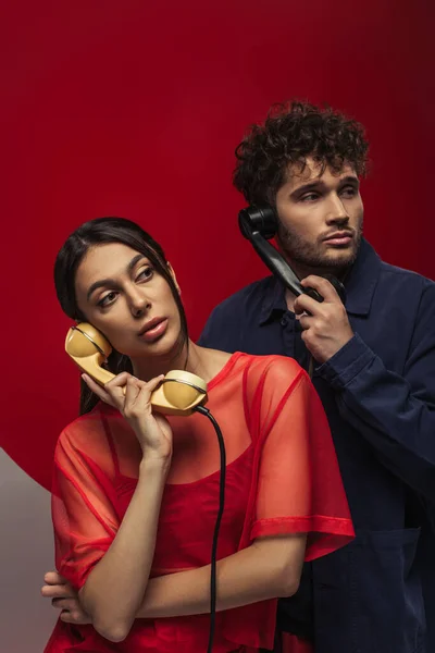 Young Woman Curly Man Holding Retro Handsets While Posing Red — Fotografia de Stock