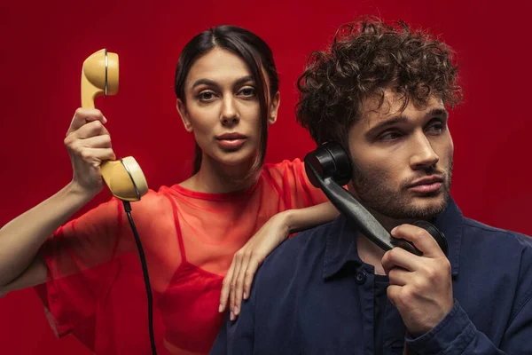 Young Woman Curly Man Holding Retro Handsets While Posing Red — Stock Photo, Image