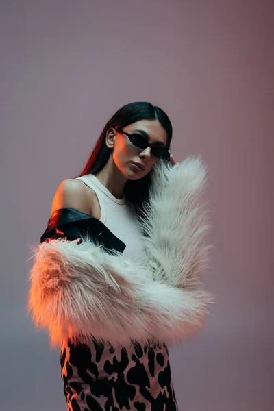 Stylish Young Woman White Faux Fur Jacket Adjusting Trendy Sunglasses — 스톡 사진
