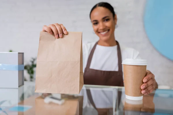 Coffee Paper Bag Hands Blurred African American Seller Sweet Shop — Fotografia de Stock