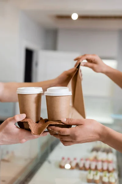 Cropped View African American Customer Taking Paper Cups Bag Seller — Fotografie, imagine de stoc