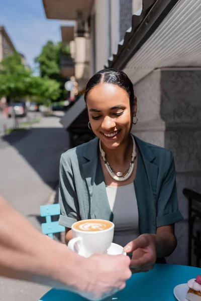 Smiling African American Woman Taking Cappuccino Waiter Dessert Terrace Sweet — стоковое фото