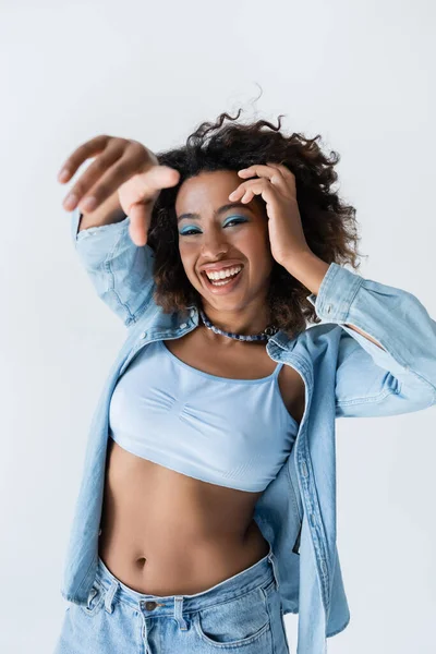 African American Woman White Crop Top Blue Denim Shirt Pointing — kuvapankkivalokuva