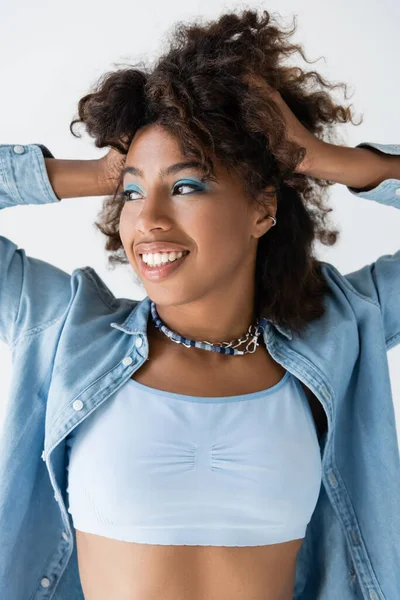 Smiling African American Woman Necklaces Denim Shirt Touching Wavy Hair — ストック写真