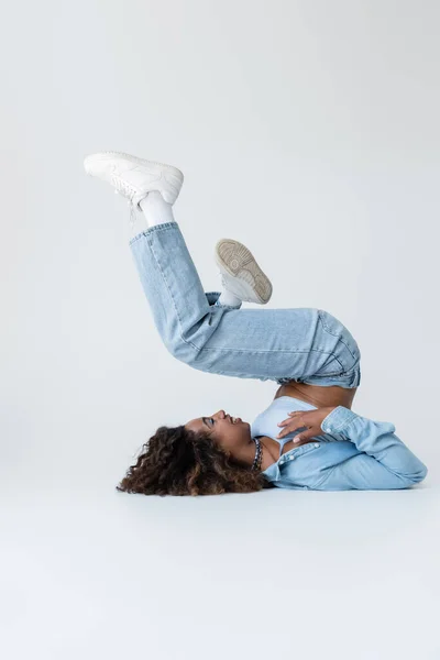 Side View African American Woman Posing Back Raised Legs Grey – stockfoto
